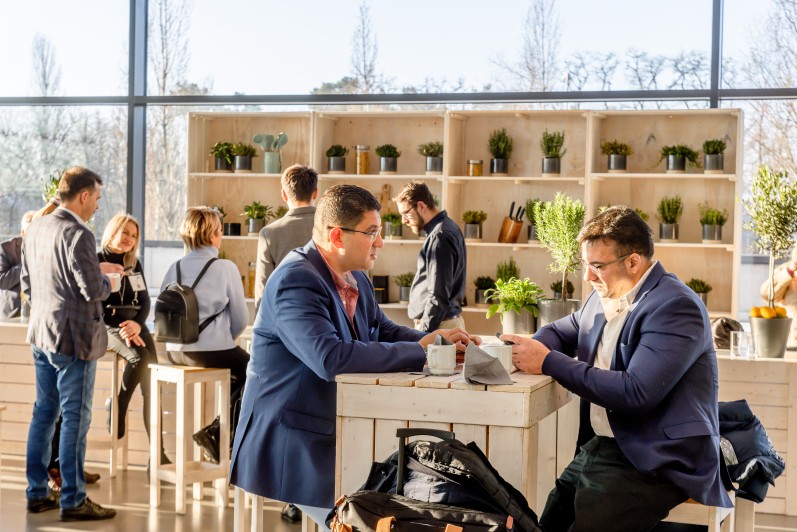 Trade visitors drink coffee in a lounge