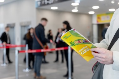 Eine Person blättert in einer FRUIT LOGISTICA Zeitschrift