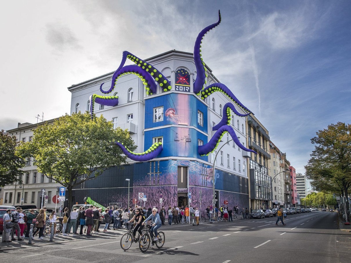 Façade of the Urban Nation Museum for Urban Contemporary Art in Berlin. The multi-storey building features an eye-catching art installation with large, colourful tentacles protruding from the windows.